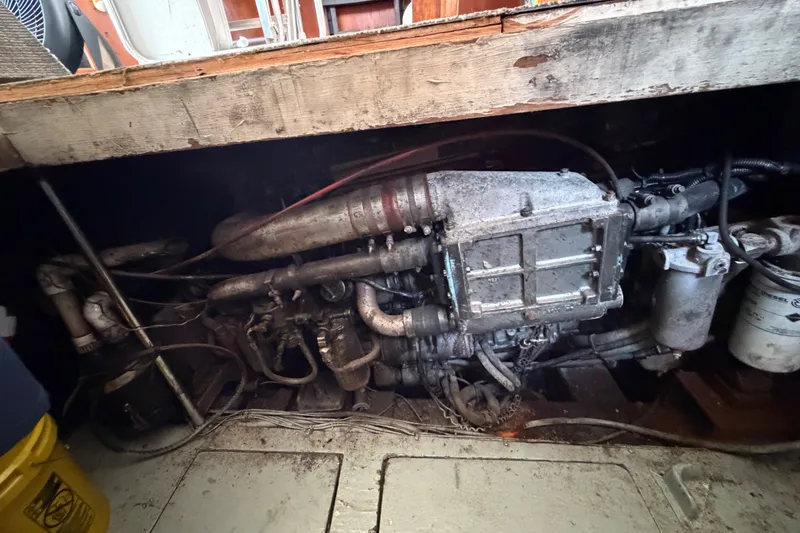 Slide: The Image of Engine compartment of a 1989 Egg Harbor 41 Convertible boat, showing mechanical components. - 52