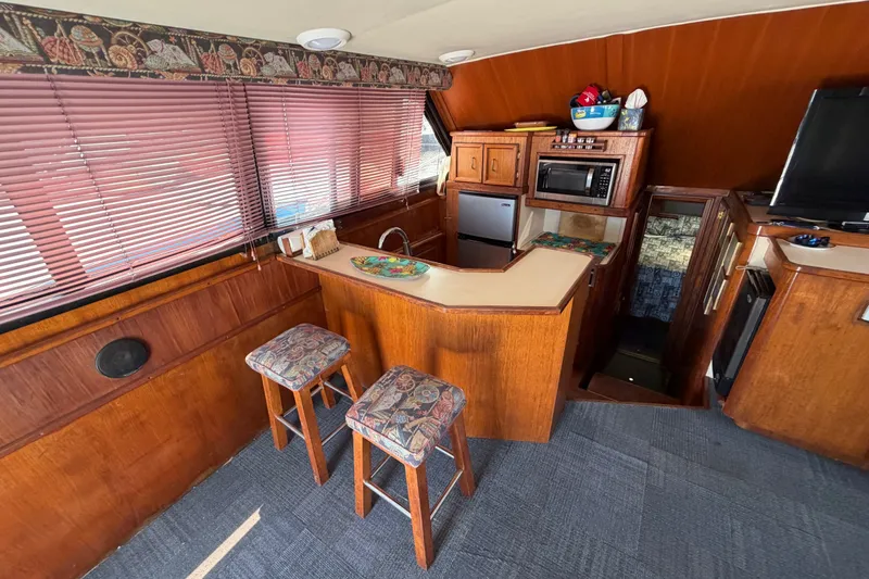 Slide: The Image of Interior of 1989 Egg Harbor 41 Convertible yacht with kitchen and seating area. - 14