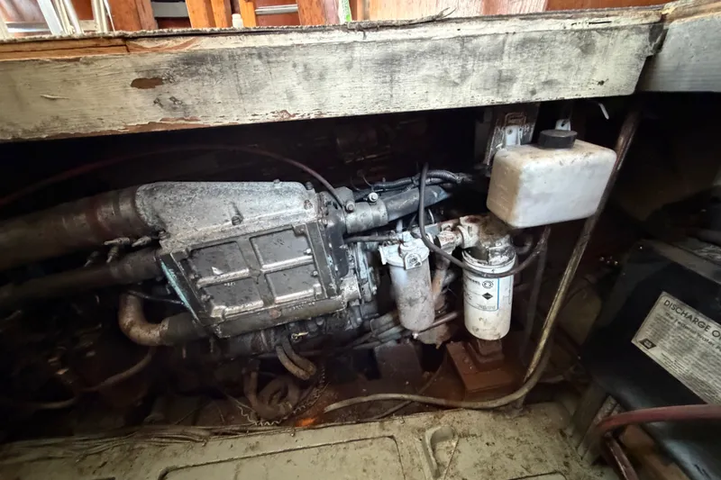 Slide: The Image of Engine compartment of a 1989 Egg Harbor 41 Convertible boat, showing mechanical components. - 51