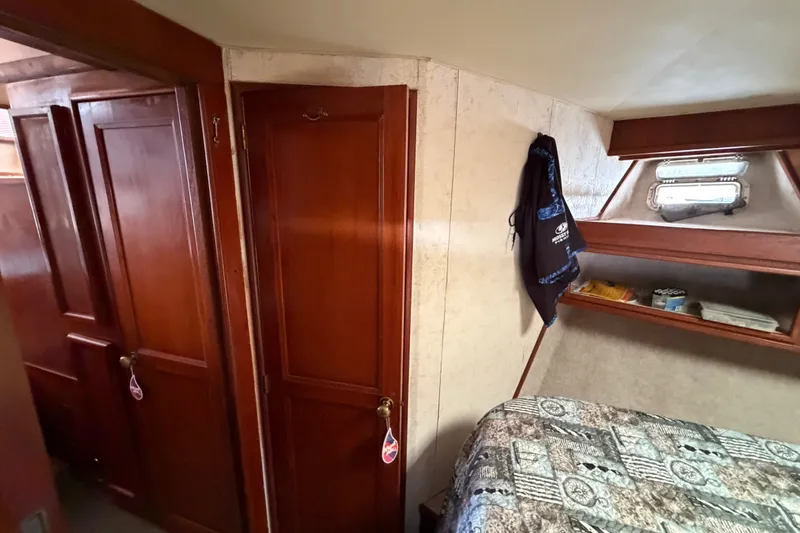 Slide: The Image of Interior cabin of 1989 Egg Harbor 41 Convertible yacht with wooden doors and cozy bedding. - 28