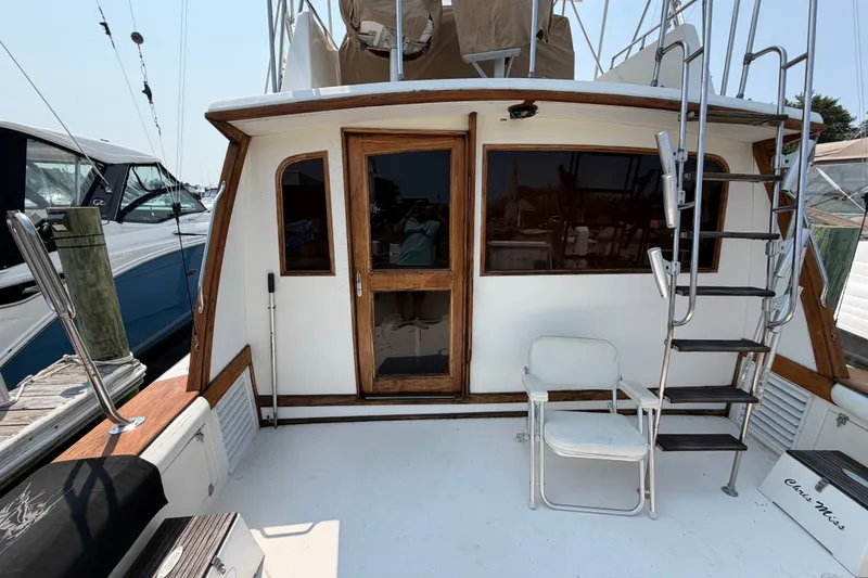 Slide: The Image of 1989 Egg Harbor 41 Convertible yacht deck with seating and ladder. - 9