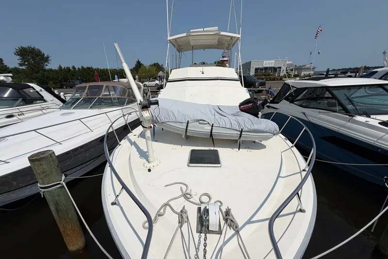 Slide: The Image of 1989 Egg Harbor 41 Convertible yacht docked, showcasing spacious deck and sleek design. - 44