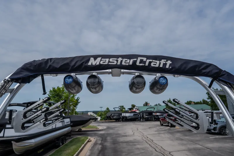 Slide: The Image of 2012 MasterCraft X55 boat with wakeboard tower and speakers in a marina setting. - 50