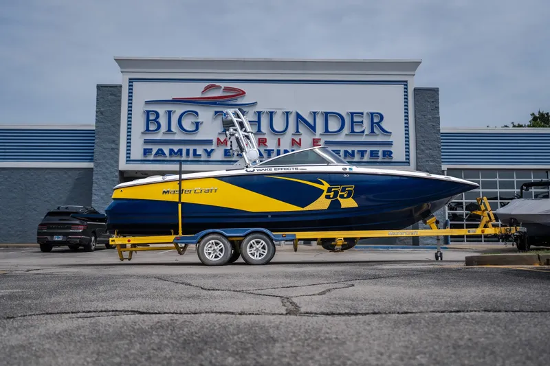 The Image of 2012 MasterCraft X55 boat on trailer at Big Thunder Marine dealership. - 1