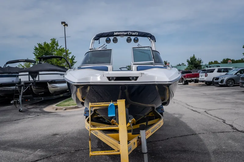 Slide: The Image of 2012 MasterCraft X55 boat on trailer in parking lot. - 11
