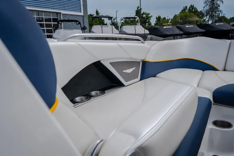Slide: The Image of Interior of 2012 MasterCraft X55 boat with white and blue seating, cup holders, and sleek design. - 32