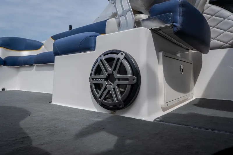 Slide: The Image of 2012 MasterCraft X55 boat interior with JL Audio speaker and blue seating. - 46