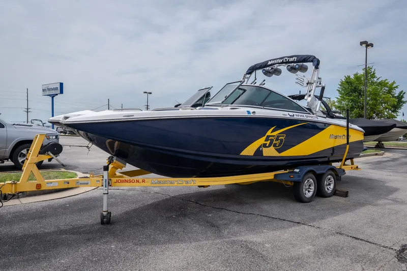 Slide: The Image of 2012 MasterCraft X55 boat on trailer in parking lot. - 12