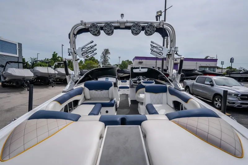 Slide: The Image of 2012 MasterCraft X55 boat with luxurious seating and modern design in a dealership lot. - 17