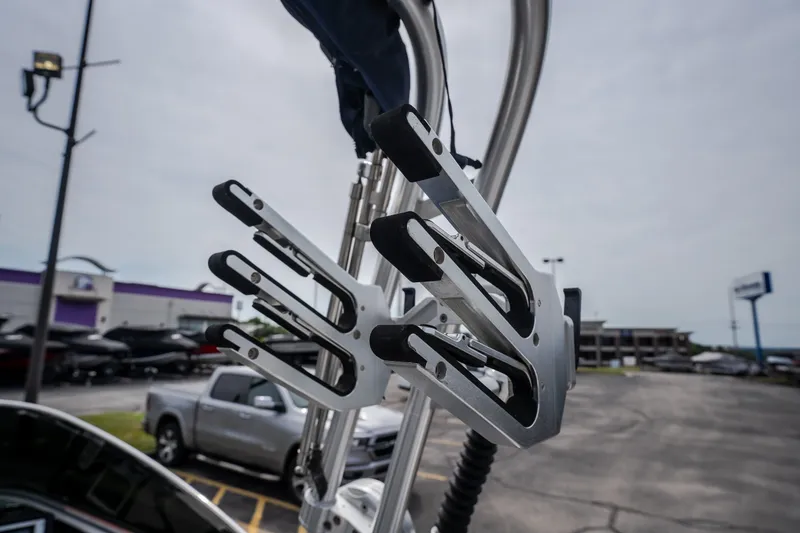 Slide: The Image of 2012 MasterCraft X55 wakeboard rack on a boat, with parking lot background. - 20