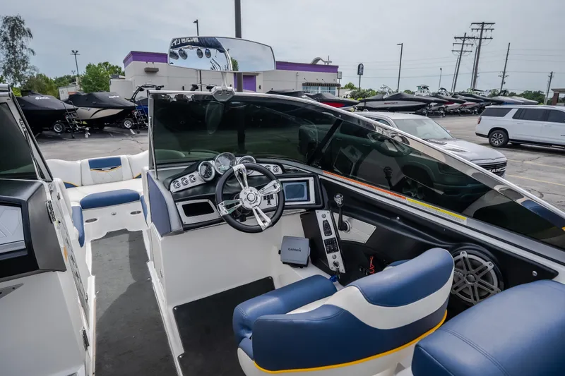 Slide: The Image of Interior view of a 2012 MasterCraft X55 boat, showcasing the steering console and seating. - 21