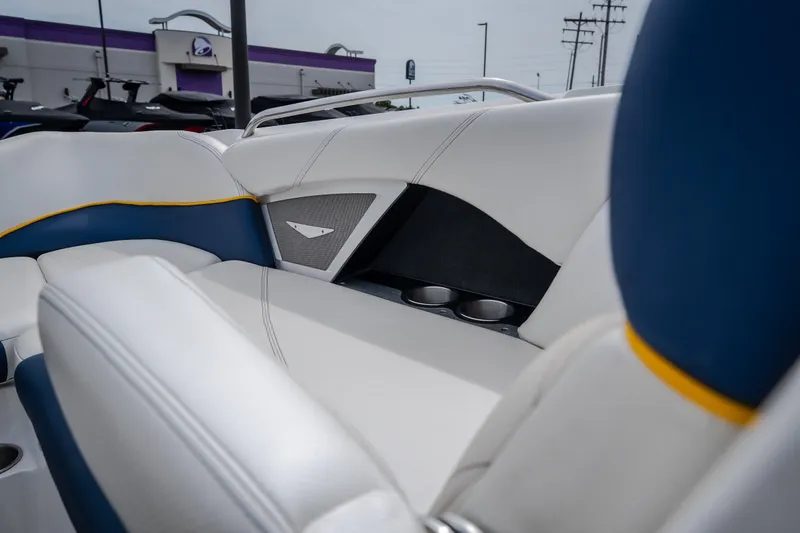 Slide: The Image of Interior of 2012 MasterCraft X55 boat with white and blue seating, cup holders visible. - 33