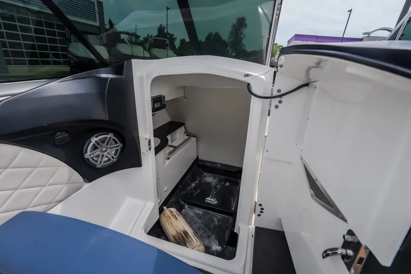 Slide: The Image of 2012 MasterCraft X55 boat interior storage compartment with speaker and seating. - 25