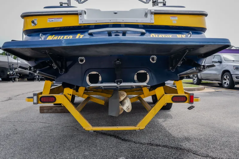 Slide: The Image of Rear view of a 2012 MasterCraft X55 boat on a yellow trailer. - 3