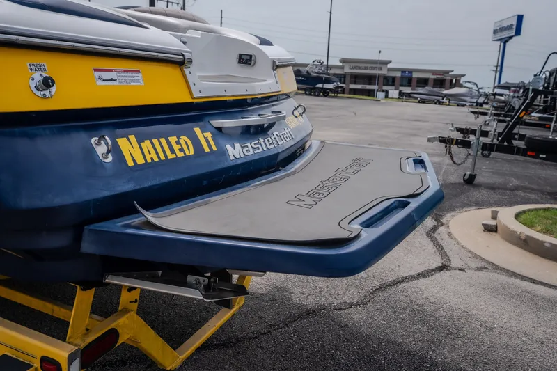 Slide: The Image of 2012 MasterCraft X55 boat with "Nailed It" decal, parked on a trailer. - 5