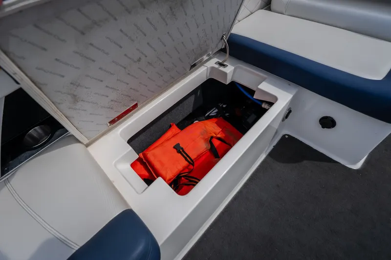 Slide: The Image of Storage compartment in 2012 MasterCraft X55 boat with life jacket inside. - 51