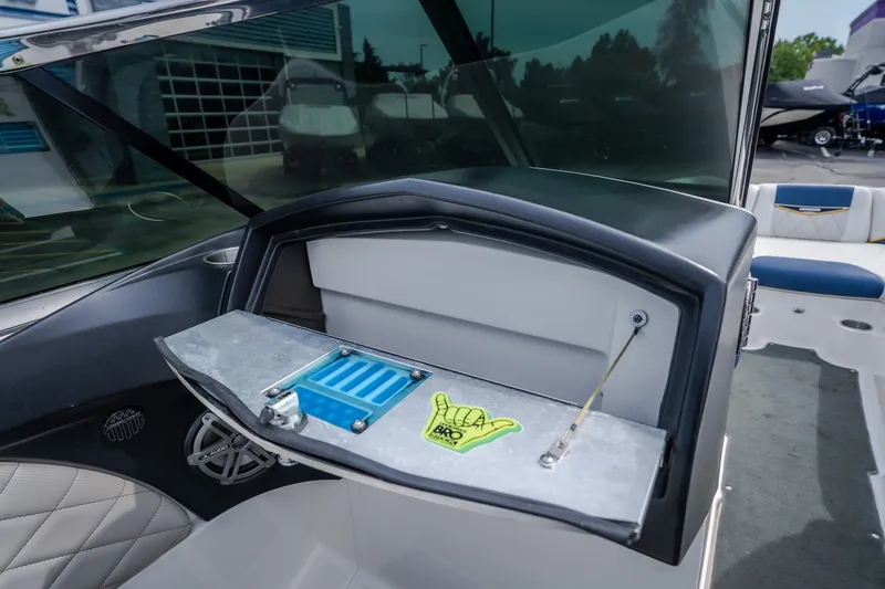Slide: The Image of Interior of a 2012 MasterCraft X55 boat featuring a storage compartment and speaker. - 24