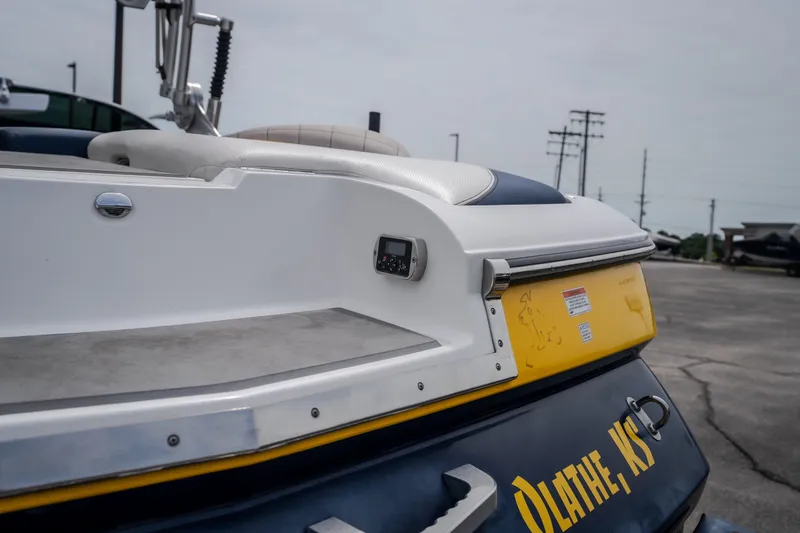Slide: The Image of 2012 MasterCraft X55 boat rear view, featuring sleek design and Olathe, KS lettering. - 6