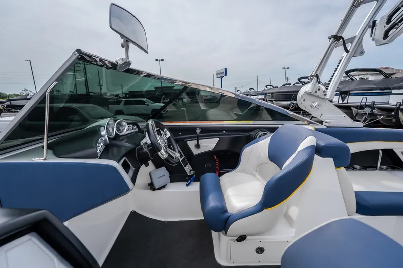 Slide: The Image of 2012 MasterCraft X55 boat interior with blue and white seating and modern dashboard. - 28