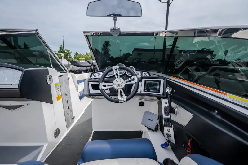 Slide: The Image of 2012 MasterCraft X55 boat cockpit with steering wheel and navigation controls. - 22