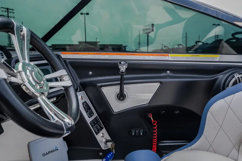 Slide: The Image of Interior of a 2012 MasterCraft X55 boat featuring steering wheel and control panel. - 38