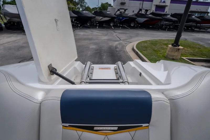 Slide: The Image of 2012 MasterCraft X55 boat interior with open storage compartment, parked outdoors. - 34