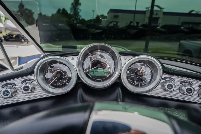 Slide: The Image of Dashboard of a 2012 MasterCraft X55 boat with gauges and controls. - 43