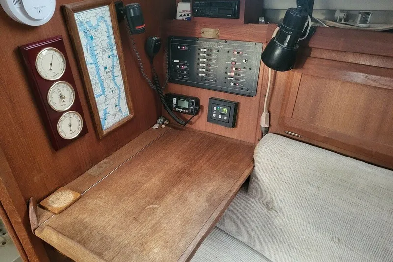 Slide: The Image of Navigation station of a 1993 Hunter Marine 30 sailboat with instruments and map. - 5