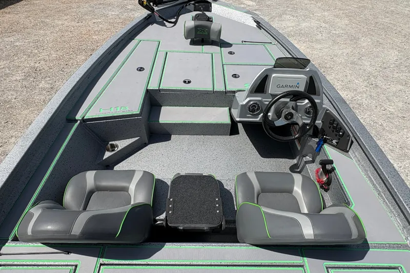 Slide: The Image of 2023 Xpress H18 boat interior with Garmin system, gray seats, and green accents. - 14