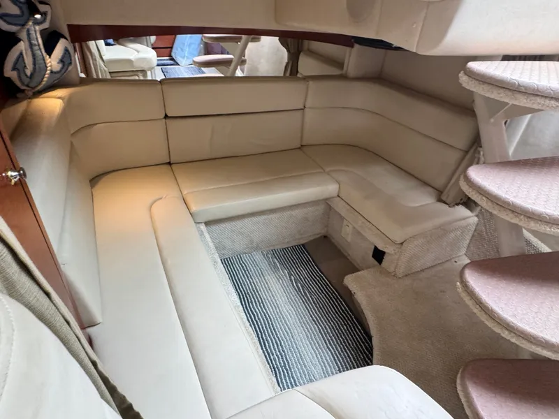 Slide: The Image of Interior of a 2004 Sea Ray Sundancer 320 with beige upholstered sofa and carpet. - 13