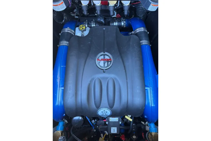 Slide: The Image of 2021 MasterCraft X24 engine with blue hoses and Ilmor branding. - 14