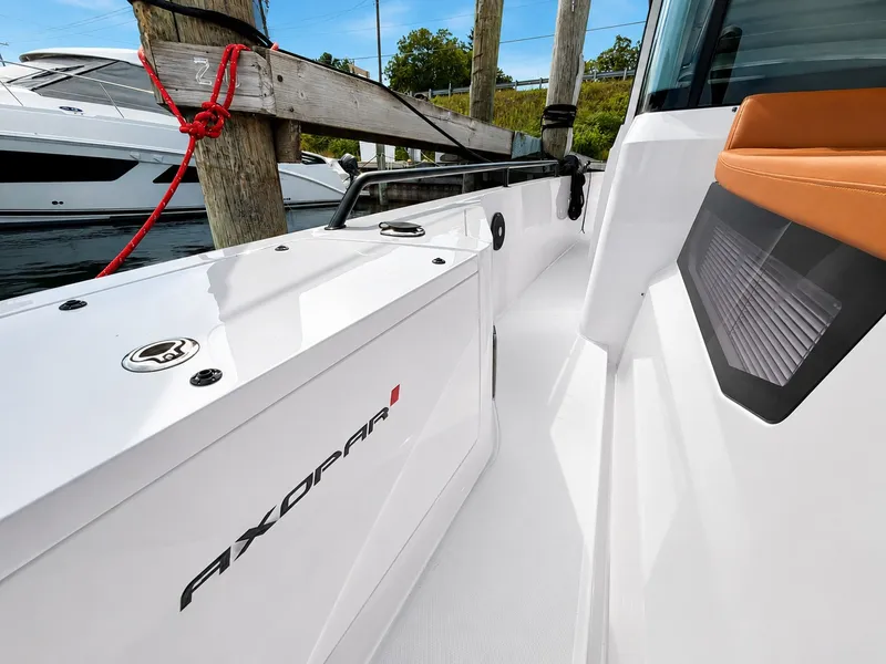 Slide: The Image of The 2022 Axopar Brabus 37 XC Cross Cabin is docked. White surface with sleek lines. - 17