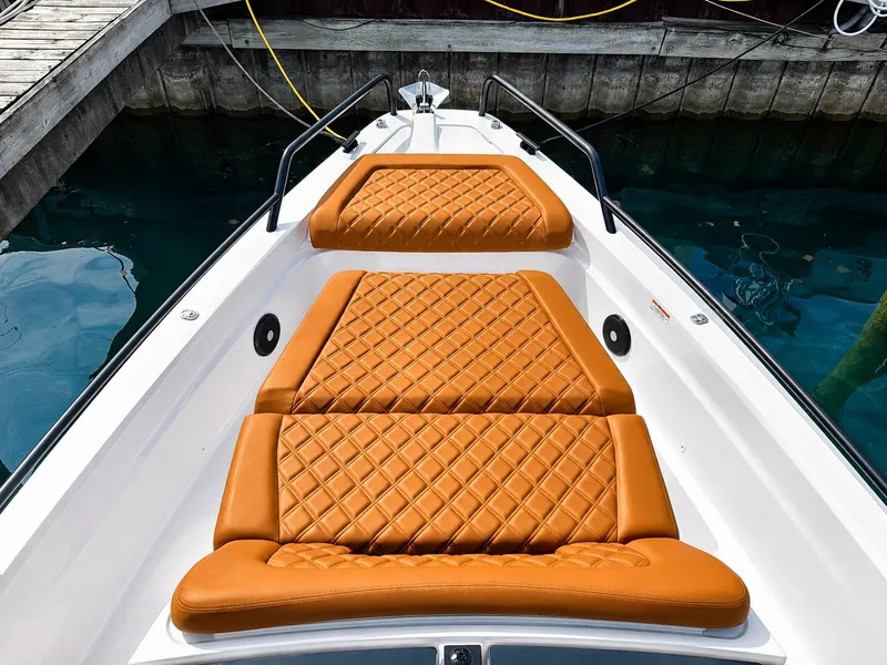 Slide: The Image of The image shows the foredeck of a 2022 Axopar Brabus 37 XC Cross Cabin with orange upholstery. - 20