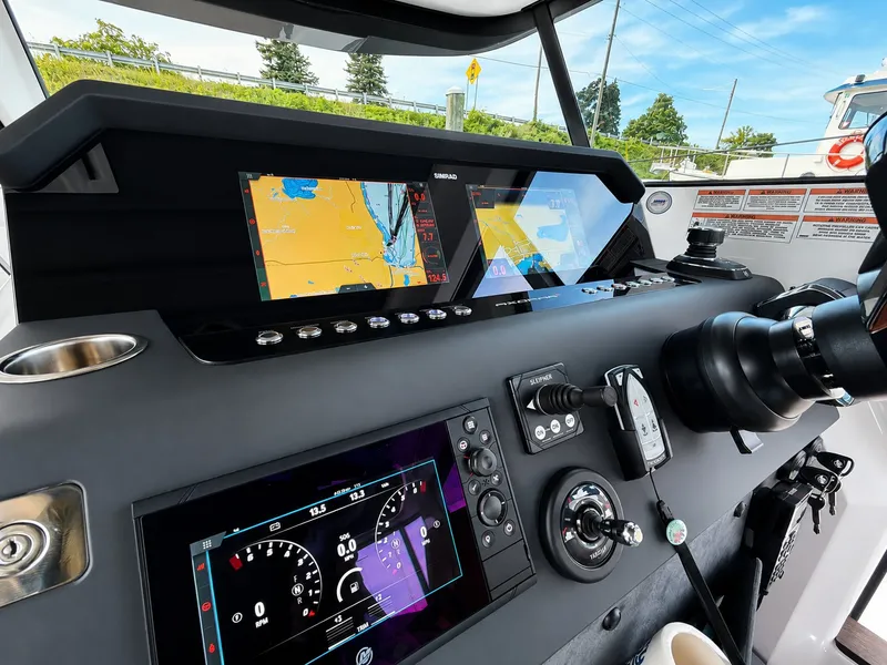 Slide: The Image of The image shows the cockpit of a 2022 Axopar Brabus 37 XC Cross Cabin with modern instruments. - 30