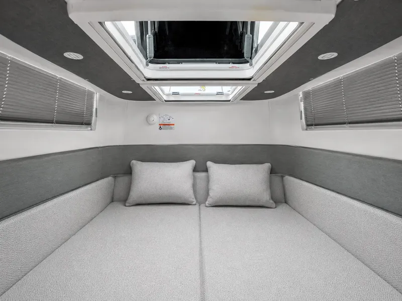 Slide: The Image of Interior of the 2022 Axopar Brabus 37 XC Cross Cabin with gray upholstery and a skylight. - 37