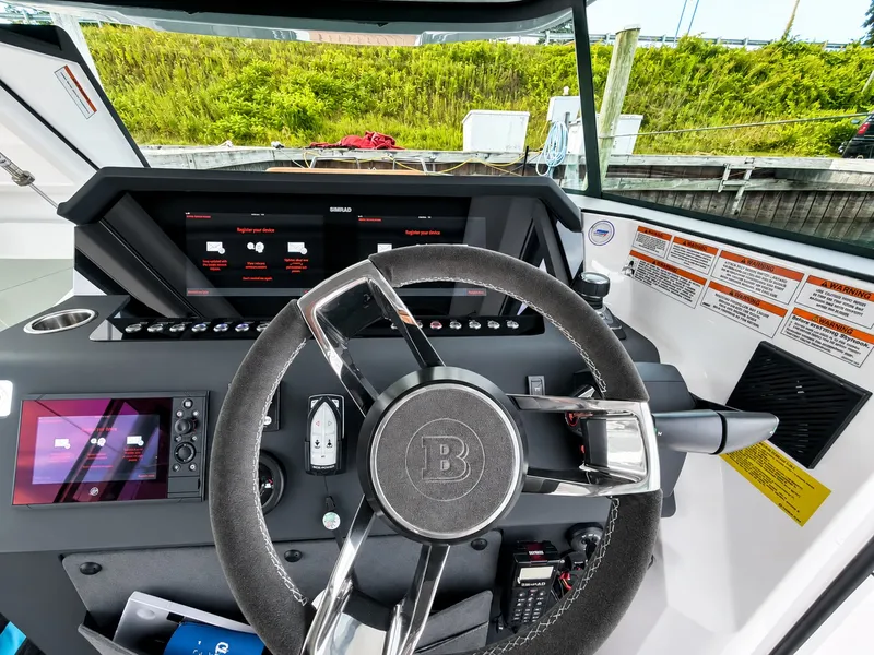 Slide: The Image of The cockpit of the 2022 Axopar Brabus 37 XC Cross Cabin with modern steering wheel and instruments. - 27