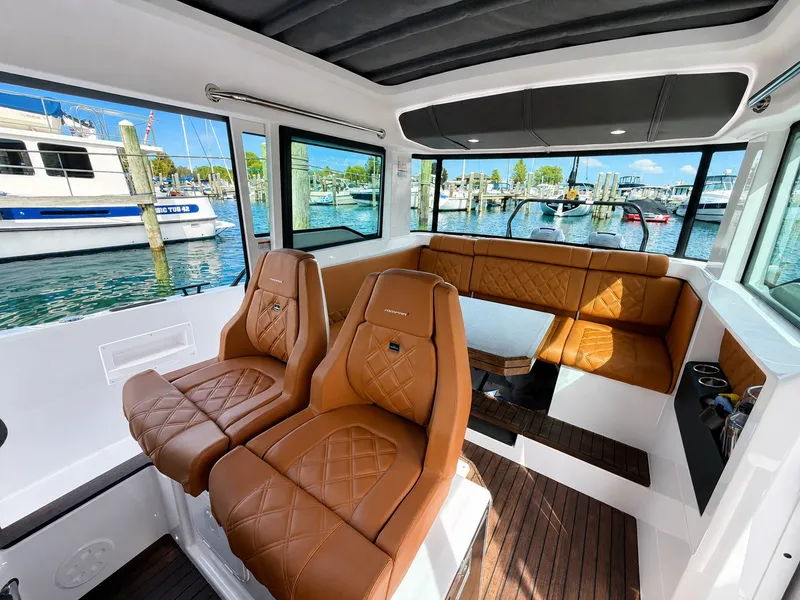 Slide: The Image of Interior of a 2022 Axopar Brabus 37 XC Cross Cabin with brown leather seats and wooden flooring. - 25