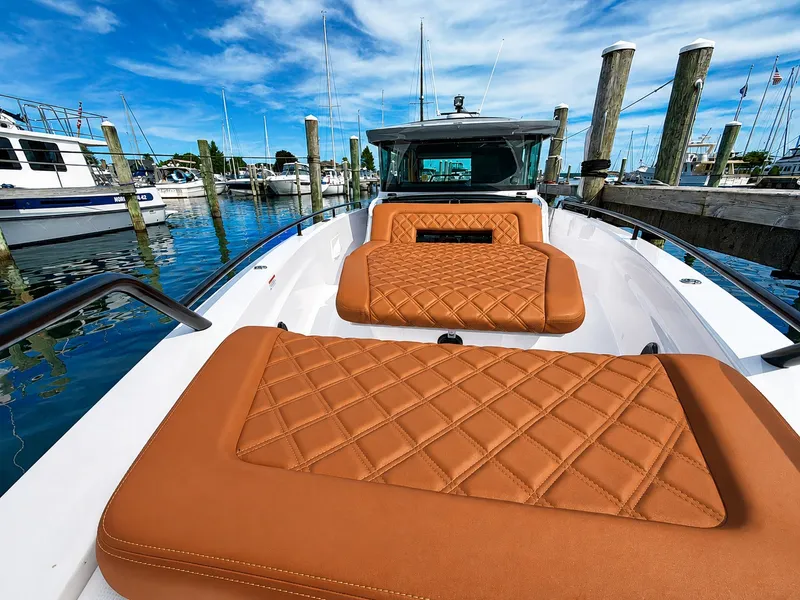 Slide: The Image of The image shows the deck of a 2022 Axopar Brabus 37 XC Cross Cabin with brown upholstery. - 18