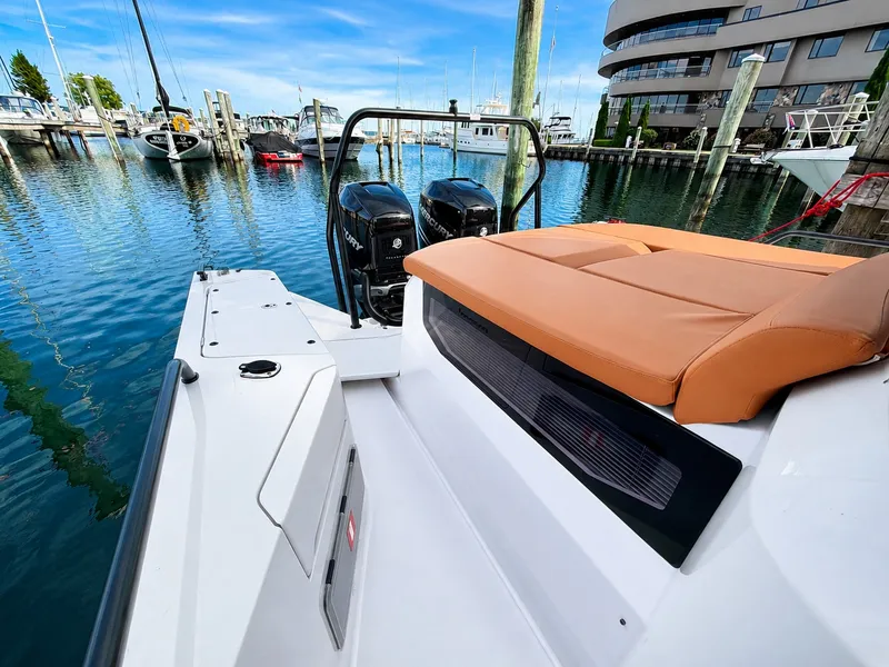 Slide: The Image of The image shows the stern of a 2022 Axopar Brabus 37 XC Cross Cabin at a marina. - 13