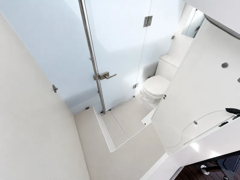 Slide: The Image of The image shows a modern yacht bathroom with a toilet and a glass door. - 33