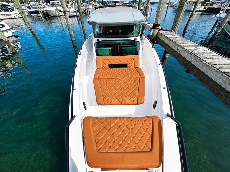 Slide: The Image of The image shows a 2022 Axopar Brabus 37 XC Cross Cabin boat with sleek brown upholstery. - 19