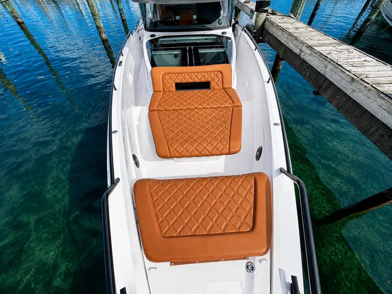 Slide: The Image of The image shows the foredeck of a 2022 Axopar Brabus 37 XC Cross Cabin with brown cushions. - 14