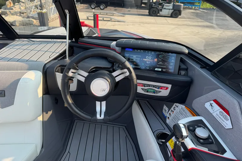 Slide: The Image of 2024 Nautique Ski Nautique dashboard with steering wheel and digital display. - 34