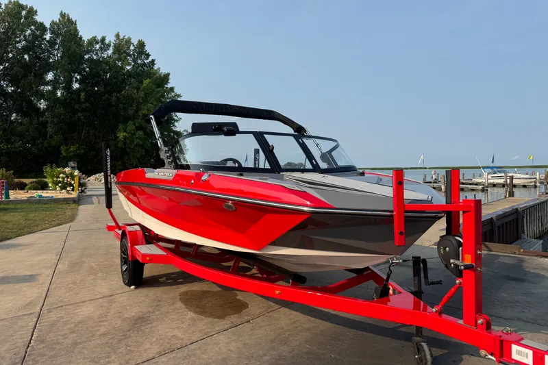 Slide: The Image of 2024 Nautique Ski Nautique boat on trailer by lakeside dock. - 7