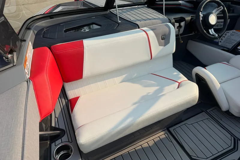 Slide: The Image of 2024 Nautique Ski Nautique interior with red and white seating, modern design, and steering wheel. - 29