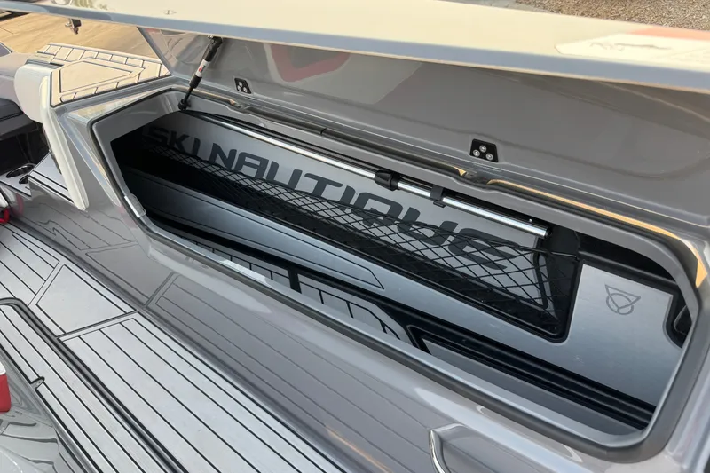 Slide: The Image of 2024 Nautique Ski Nautique storage compartment with sleek design and netting. - 20