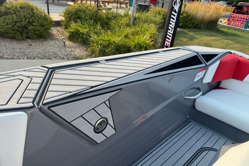 Slide: The Image of 2024 Nautique Ski Nautique boat interior with sleek design and red-white seating. - 19