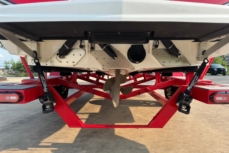 Slide: The Image of 2024 Nautique Ski Nautique boat on red trailer, showcasing propeller and rear design. - 26