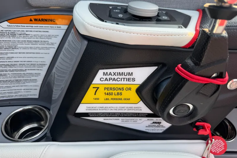 Slide: The Image of 2024 Nautique Ski Nautique dashboard showing maximum capacity warning label. - 25