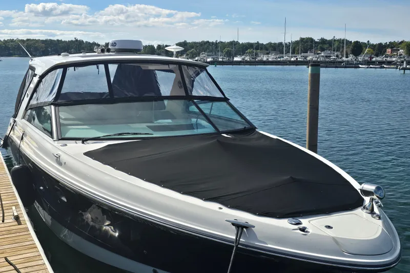 Slide: The Image of 2023 Sea Ray SLX 400 boat docked at a marina under a clear sky. - 46